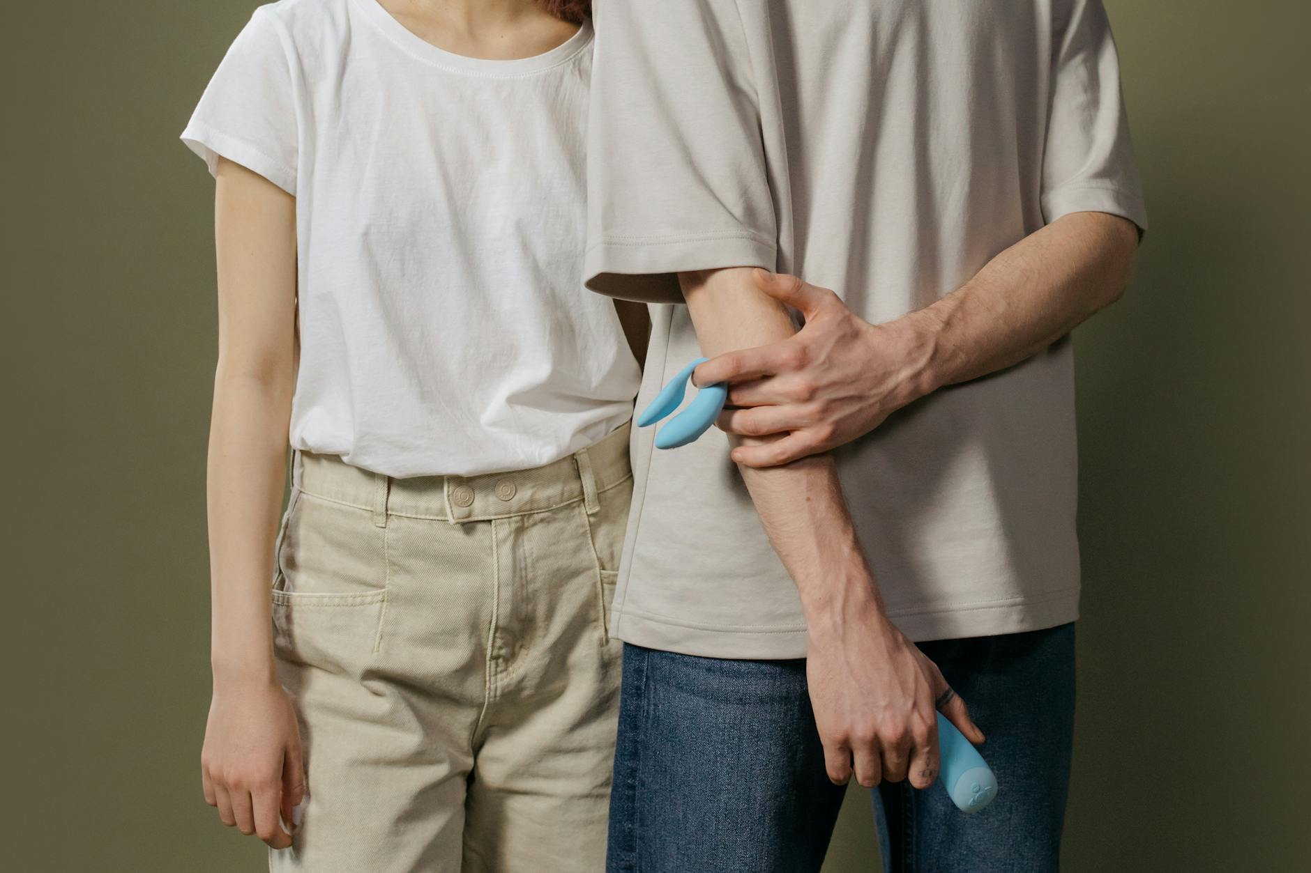 A couple standing together indoors, illustrating intimate connection and partnership in exploring pleasure together.