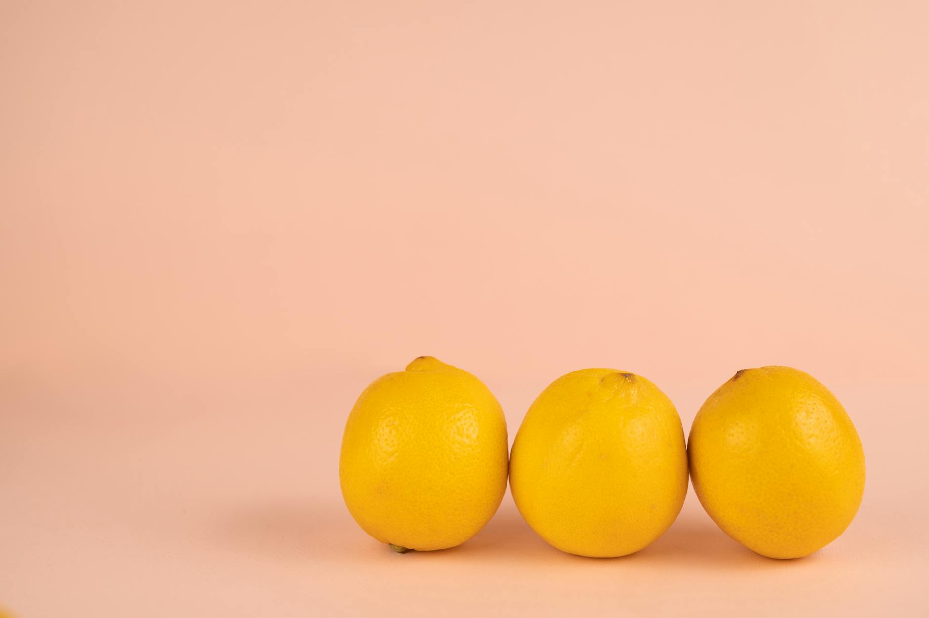 Bright yellow lemons on a pastel background, symbolizing sensitivity and natural sensation