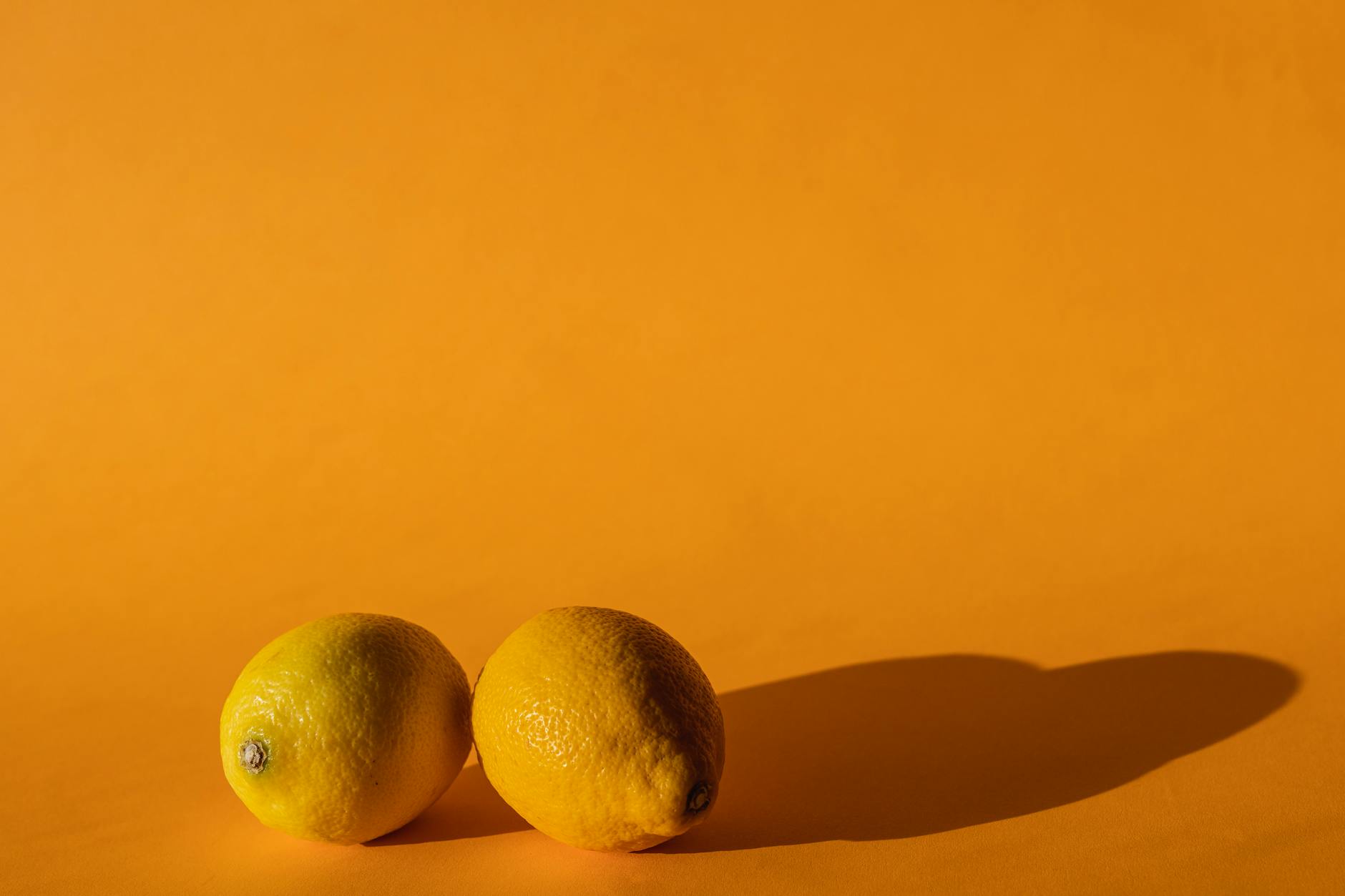 Two women smiling together with lemon slices, expressing joy and connection
