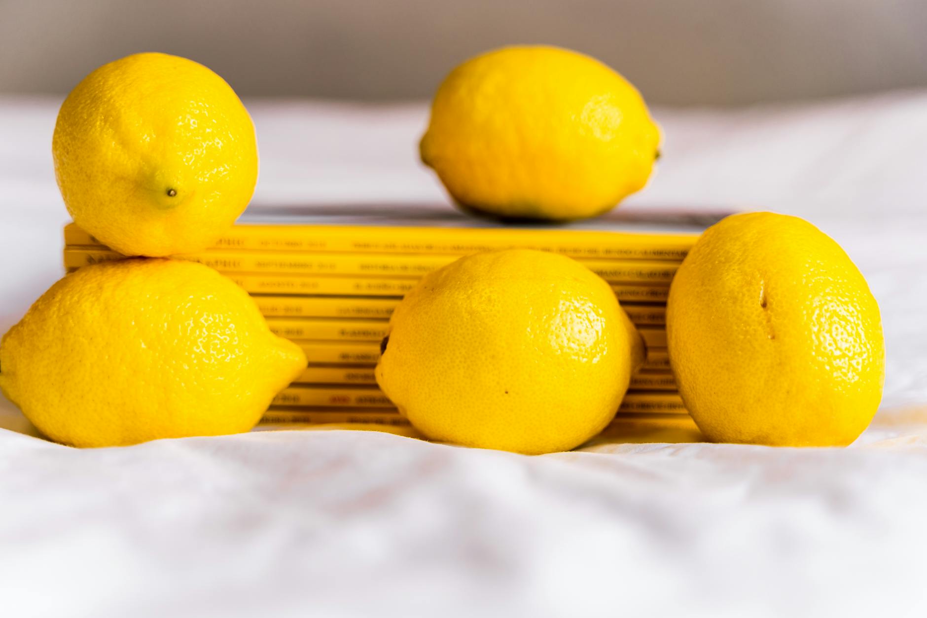 Fresh yellow lemons arranged with stacked books, symbolizing mindful pleasure and intentional self-discovery